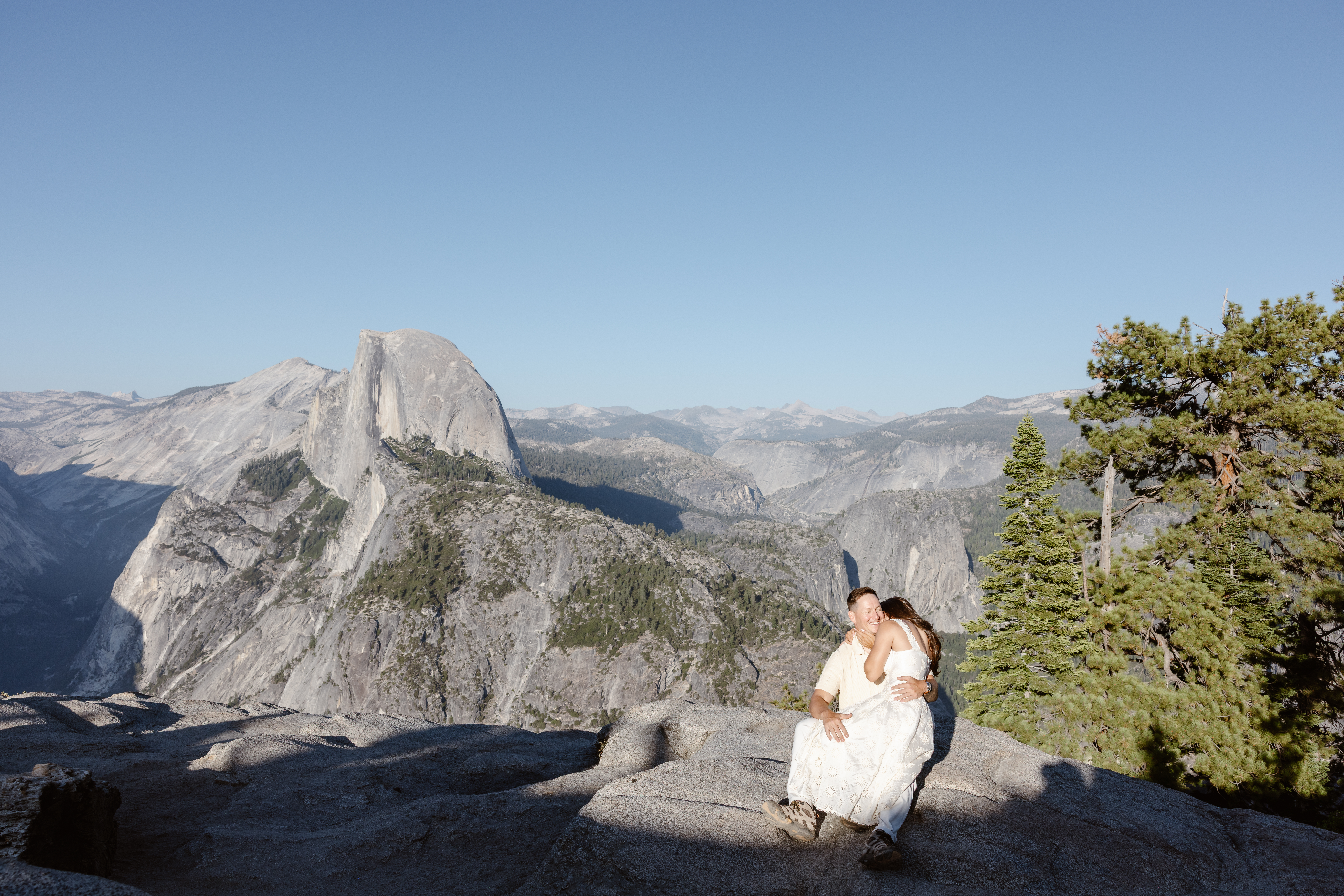 Couple hiking toward Half Dome at sunrise for their Yosemite elopement
